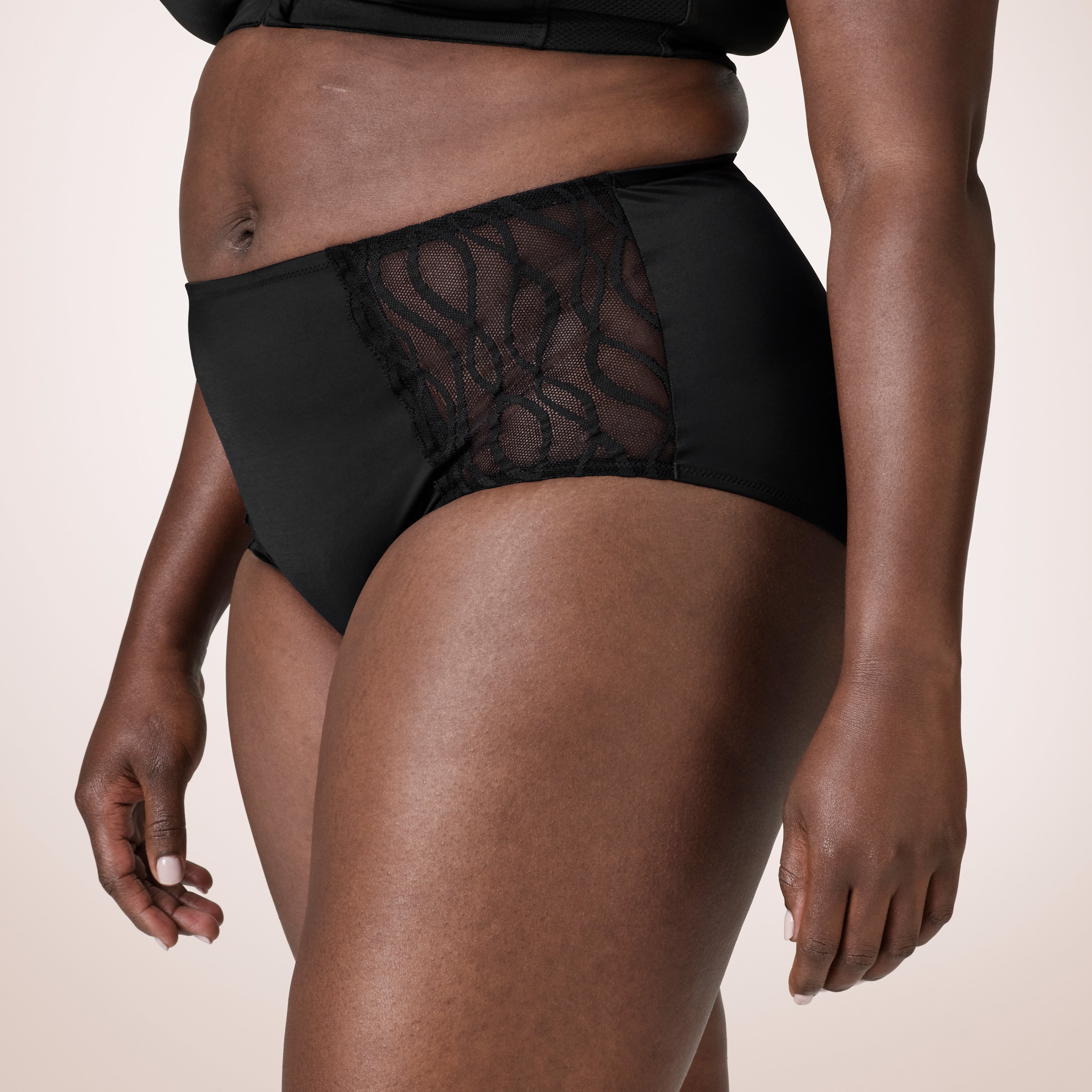 White woman wearing a pair of TENA Stylish washable underwear and showing off the stylish lace.  White woman wearing a pair of TENA Stylish washable underwear and showing off the stylish lace.
